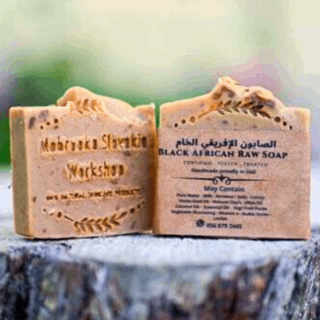 Raw butter shea African soap - hand made on wooden piece - field close up 