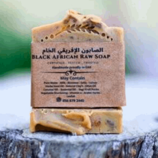 Raw butter shea African soap - hand made on wooden piece - field close up 