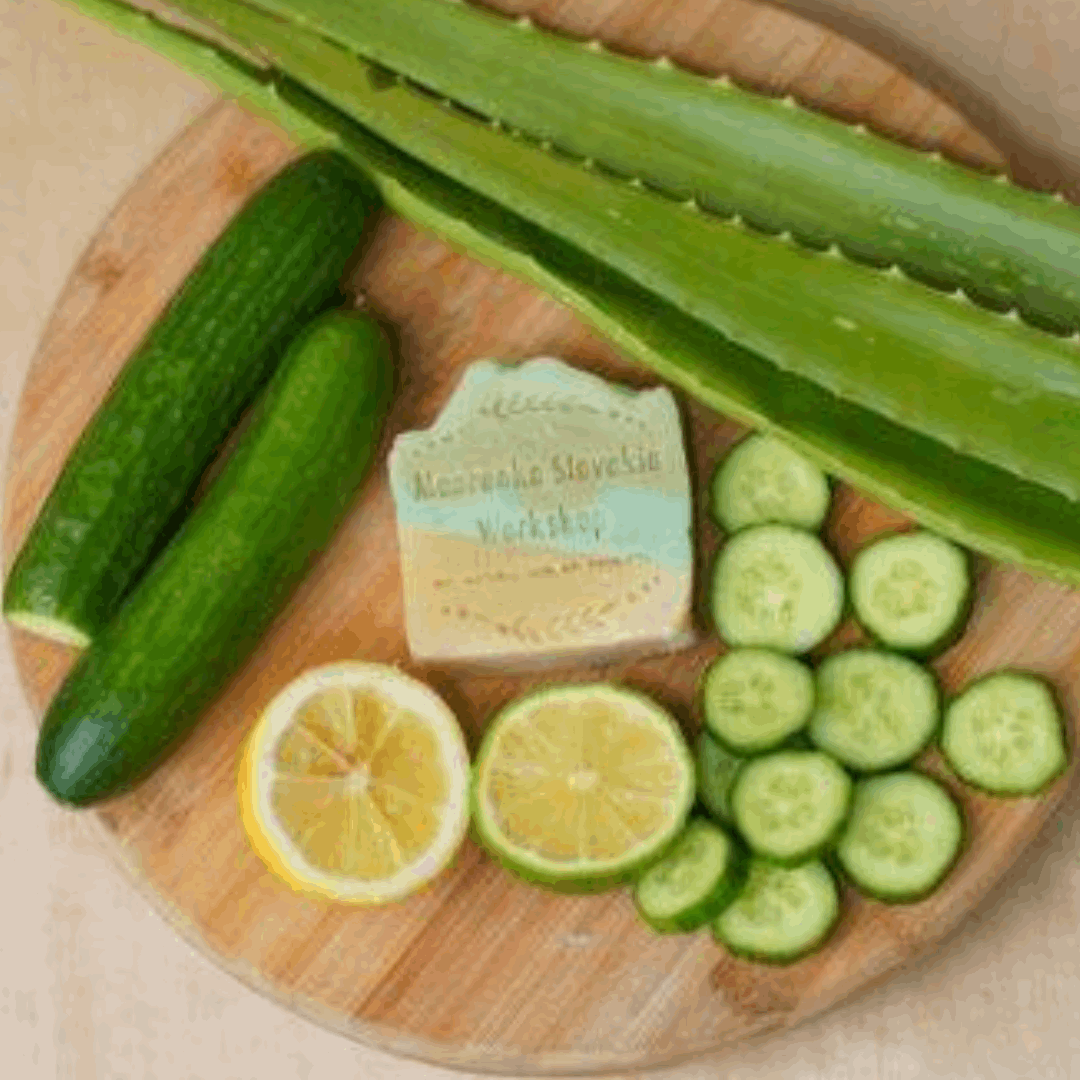 Luxurious bar soap made with cucumber slices, lemon slices, and aloe vera leaves on a wooden cutting board. Mabrooka logo in the background.