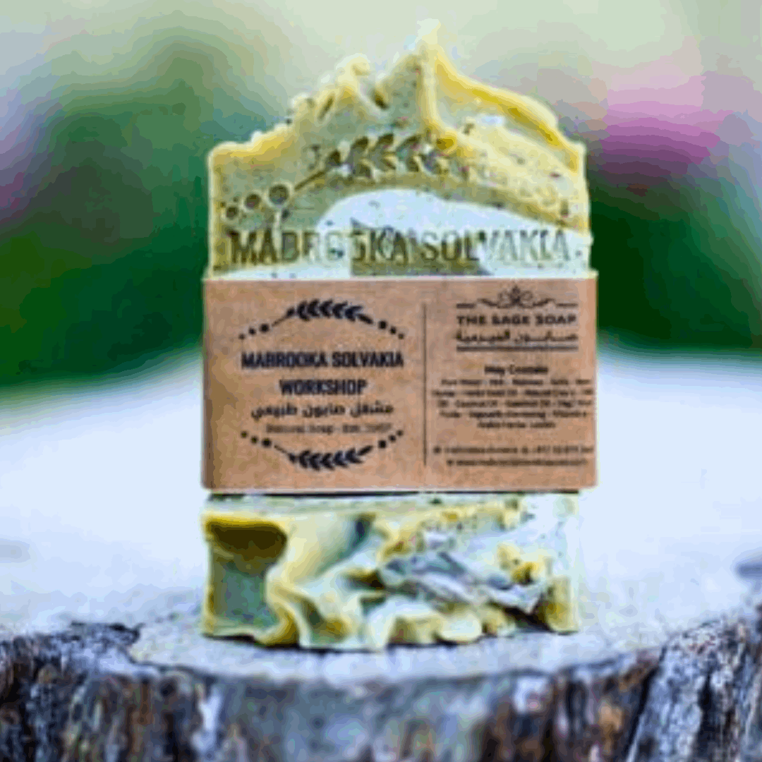 white sage hand made soap field with dried sage on wooden piece 